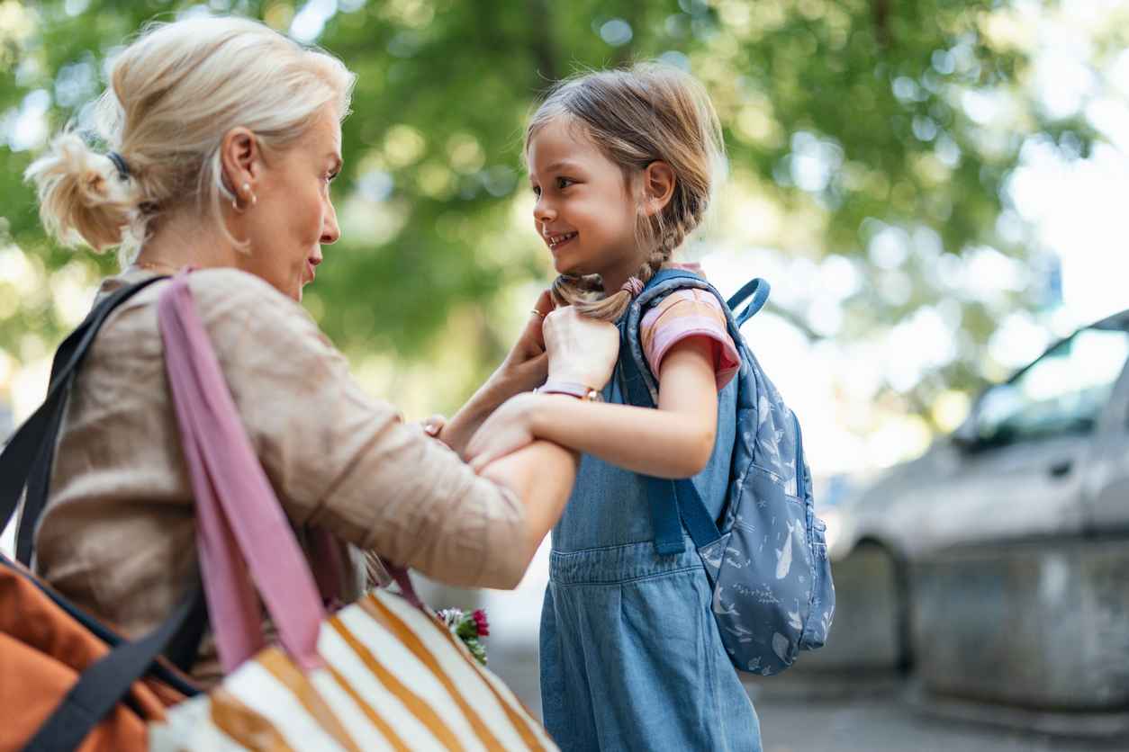 A touching moment as a mother helps her daughter get ready for school, embodying care, love, and support.
