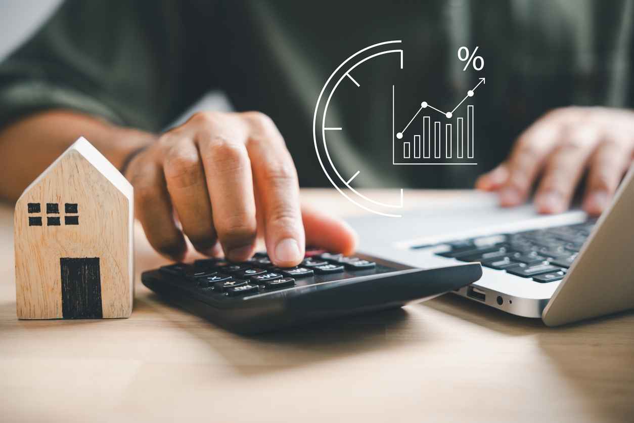 Hand using a calculator to to plan for finances.