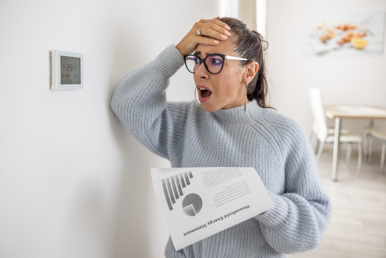 Woman Looking Shocked At Thermostat