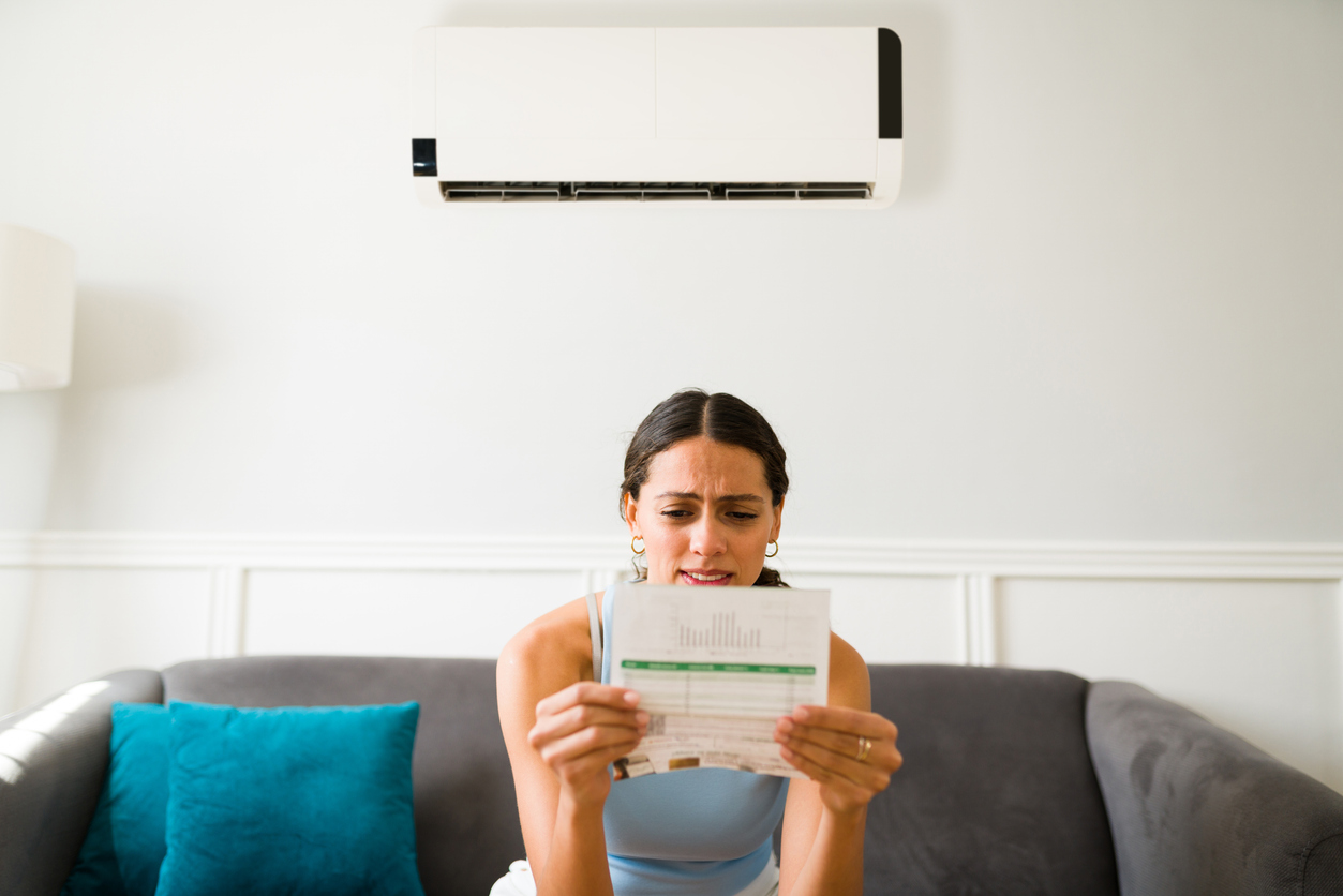 Woman Looking At High Energy Bill