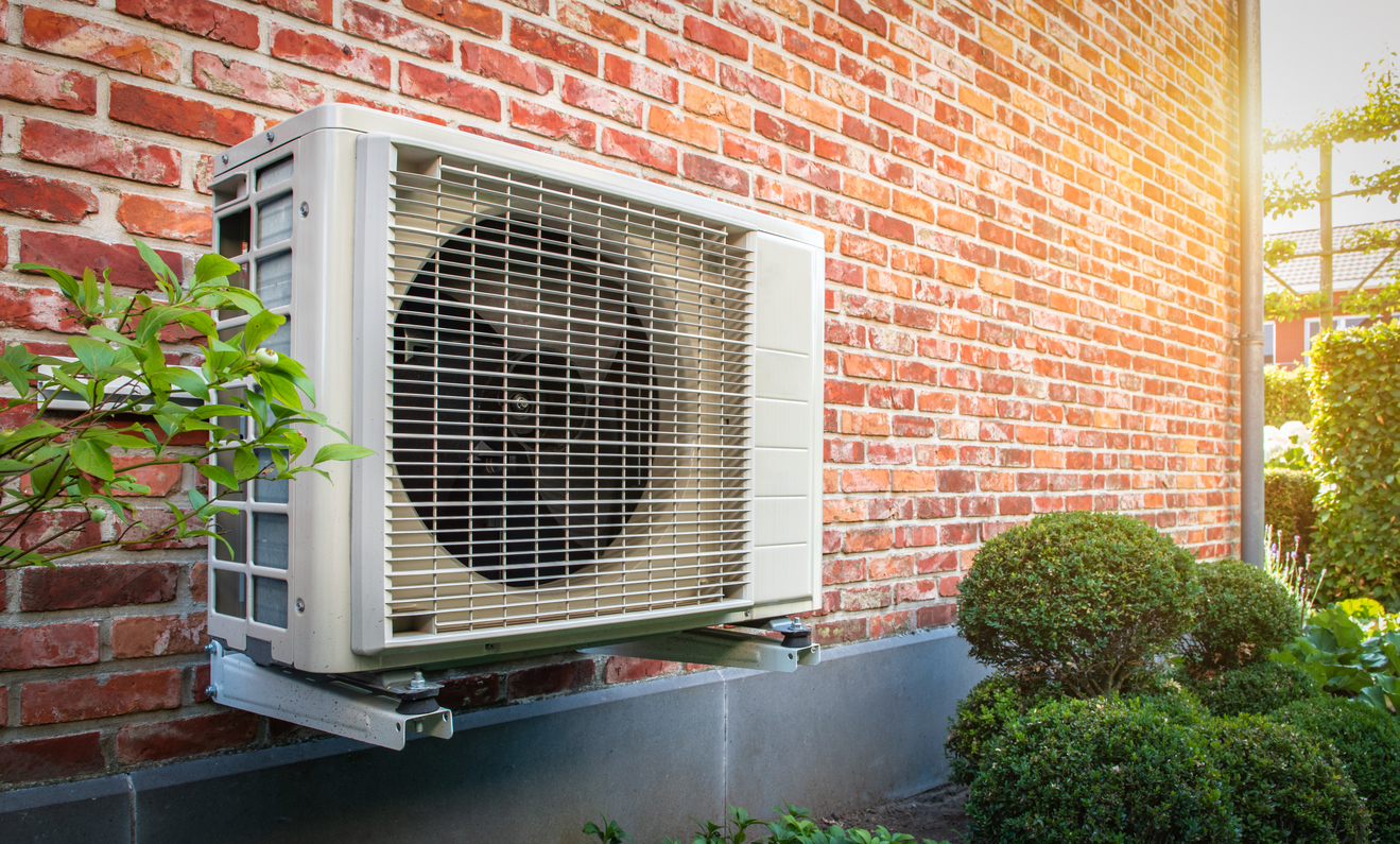 Heat Pump Against Brick Wall