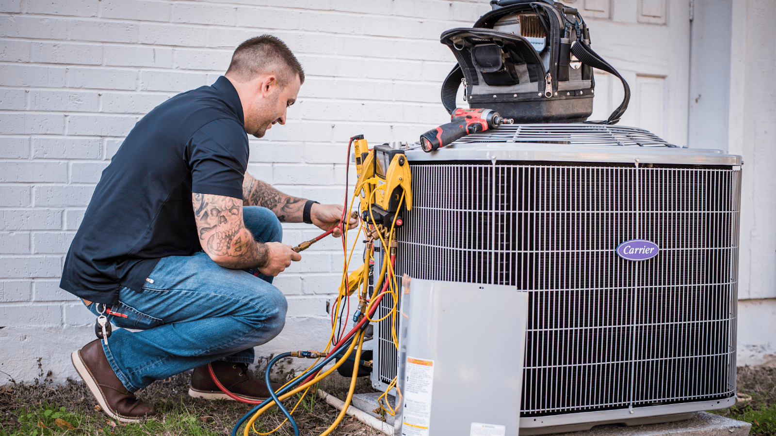 McCullough HVAC technician working on a Carrier HVAC unit