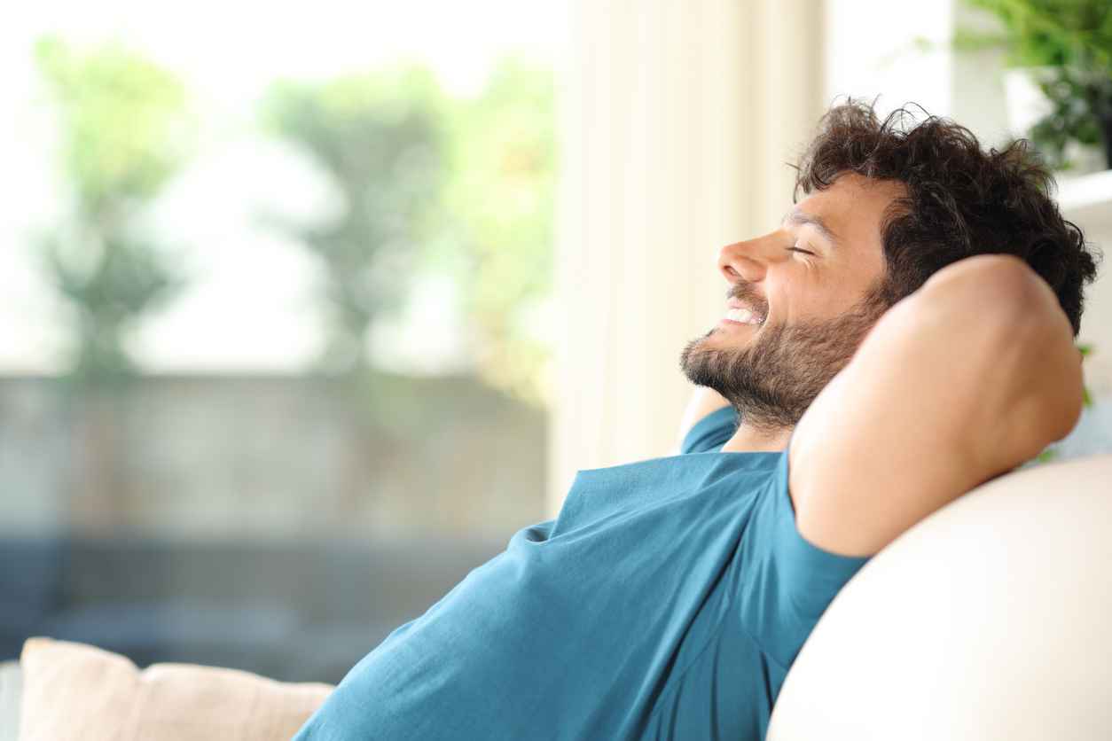 Happy man resting and relaxing at home