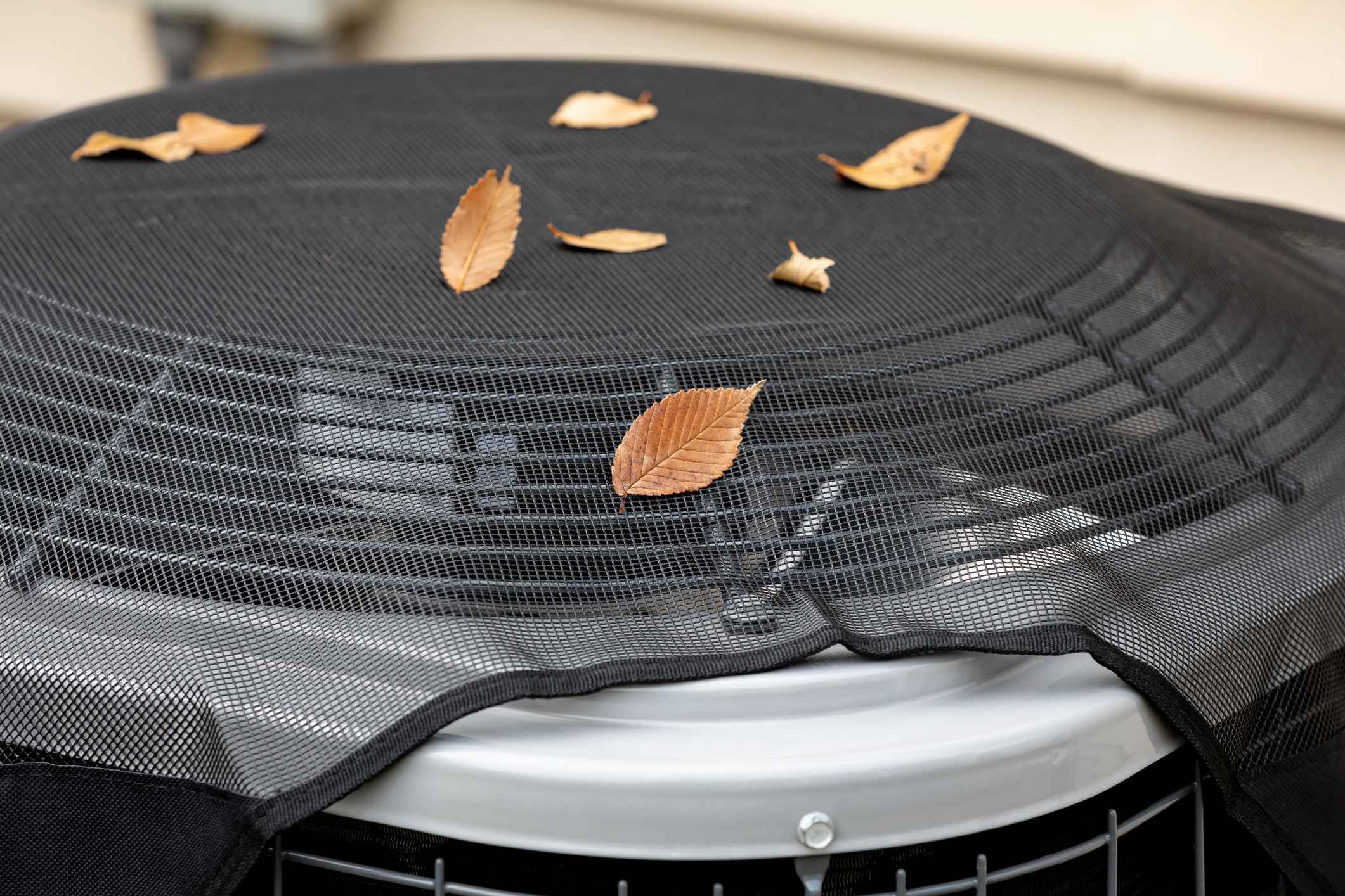 Outdoor HVAC system with leaves on top of it from the fall weather