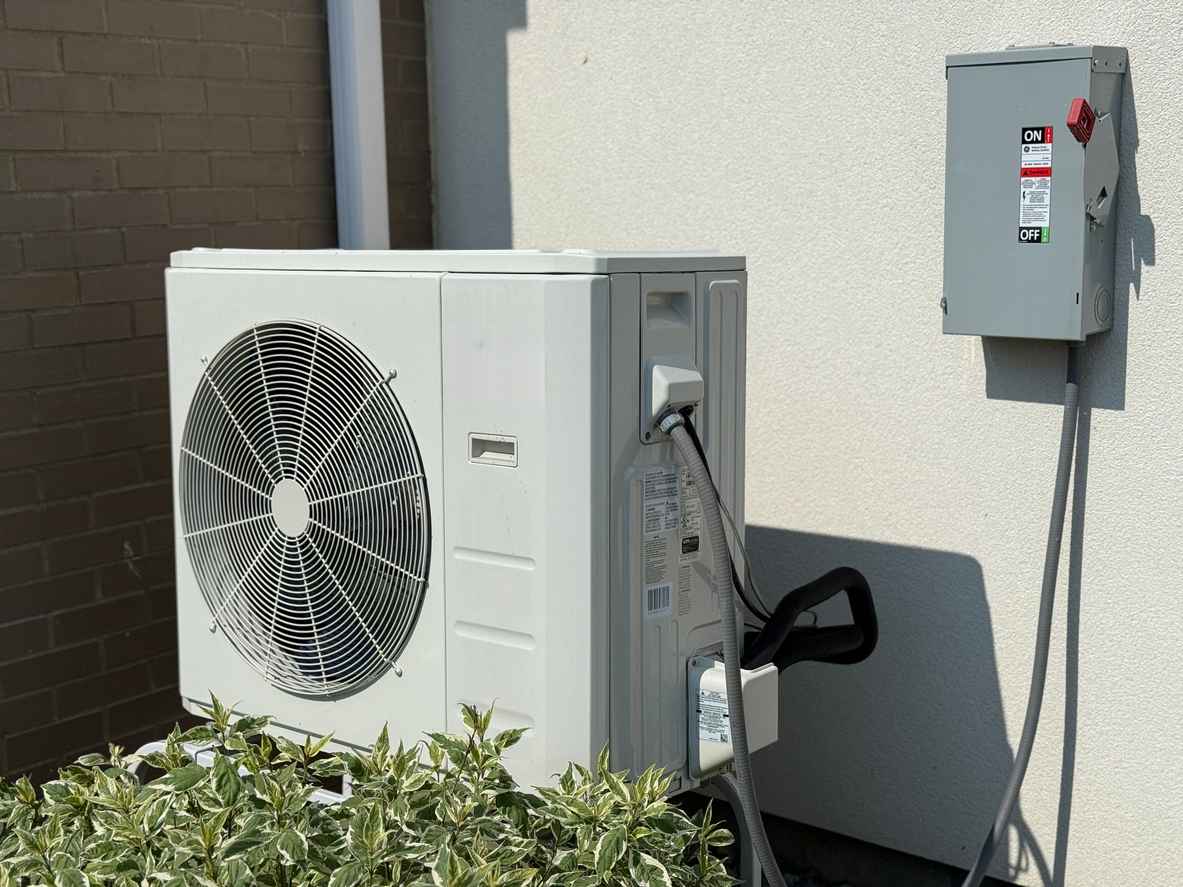 Modern heat pump on the outside of a residential home